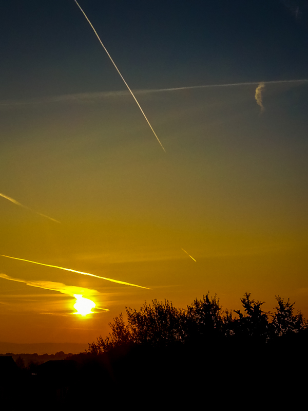 Sunrise and aeroplane vapour trails.